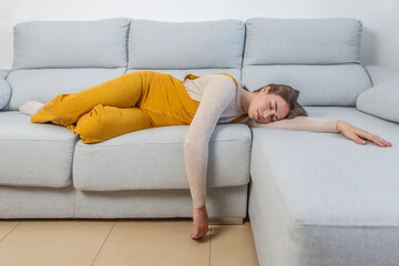 Woman lying on sofa asleep with eyes closed