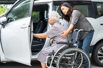 Caregiver help and support asian elderly woman sitting on wheelchair prepare get to her car to...