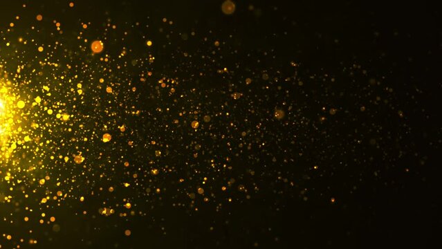 gold particles with lens flare on black background