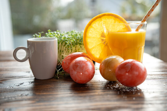 Healthy easter snack with natural ingredients and freshly squeezed orange juice and espresso on wooden table