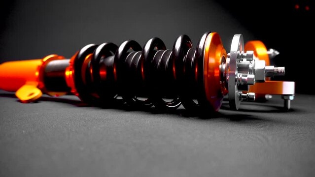 suspension tuning, coilovers, shock absorbers and front springs in yellow and gold colors for a sports drift car on a dark background