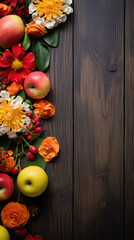 Autumn background with flowers and apples on wooden table. Top view with copy space
