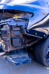 Close-up of a car with damage to the rear bumper after an accident at a service station