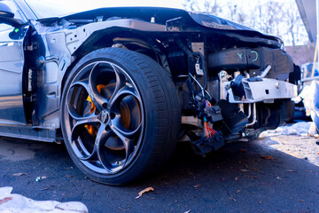 Close-up of a car with damage to the front bumper after an accident at a service station