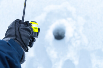 Ice fishing copy space image first person view perspective selective focus trout cold