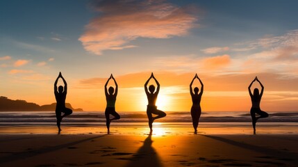Yoga wellness retreat class in morning sunrise at beach. Silhouette of five girl doing asana. Healthy lifestyle, relaxing and meditation.