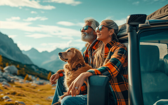 Middle aged beautiful couple with dog traveling by car in the mountains, summer vacation and adventure.