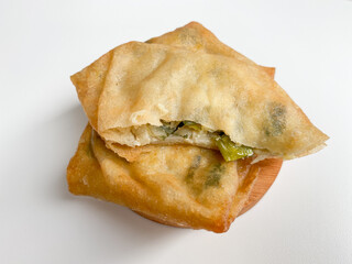 Martabak, made from flour dough, egg and leek slices. Snack from Indonesia. Isolated on white background