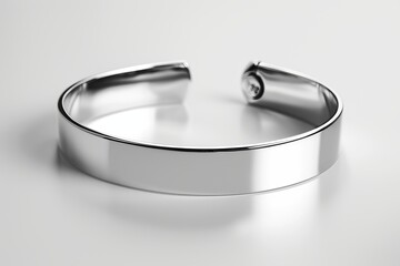 Sleek and modern silver bangle with a reflective sheen, isolated on a plain white backdrop