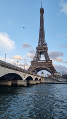 View of the Eiffel Tower from the Seine. Part of the Eifel tower just below it