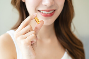 Nourishing the Body, Embracing Wellness: A Person Taking Fish Oil Supplements for Optimal Health and Vitality