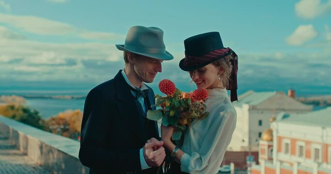 medium portrait of happy loving couple in 19th century style in beautiful city, 4K, Prores