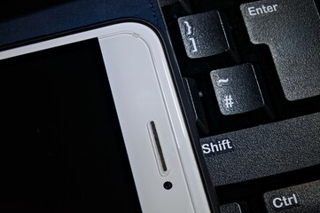 close up of a smartphone & computer keyboard