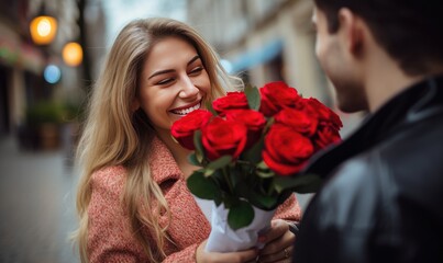 A man holding a bouquet of red roses next to a woman