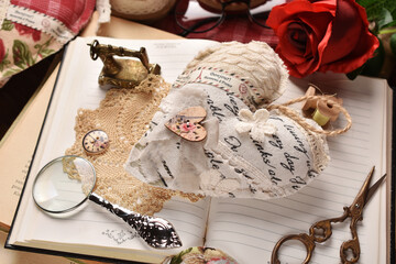 Vintage style still life with handicraft textile heart lying on opened books top view - Powered by Adobe