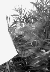 A black and white close-up double exposure portrait of a man