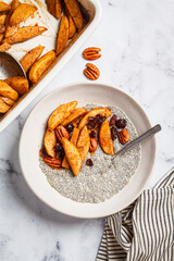 Chia pudding with caramelized apples, pecan and cranberries. Winter vegan breakfast recipe.