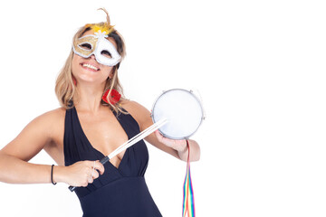 Horizontal medium shot of a young woman smiling while playing a tambourine on a white background