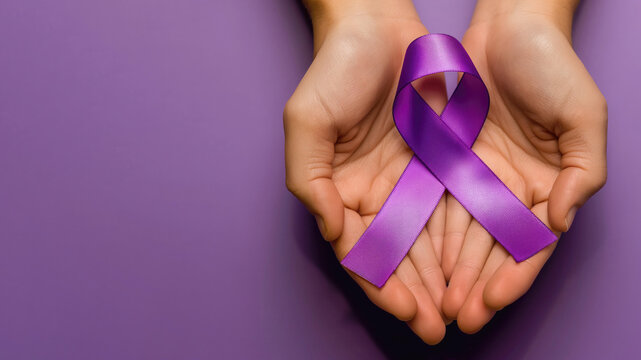 Two hands holding awareness ribbon, purple background, top view, copy space on the left