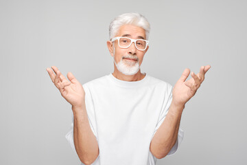 Portrait gray-haired man happy face smiling joyfully with raised palms and shocked open mouth...