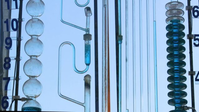 An instrument  in operation is made of glass tubes. Part of a water timer.Low angle view. Kaohsiung City,Taiwan. 4K. Real time.
