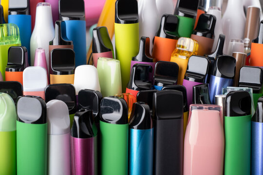 Synthetic nicotine concept. Various disposable electronic cigarettes. modern alternative smoking, vaping and nicotine. Close up