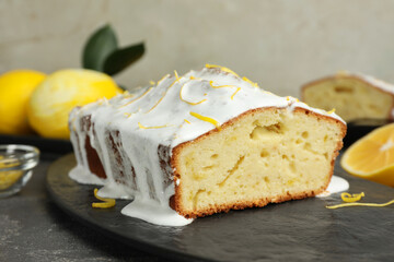 Tasty lemon cake with glaze on table, closeup