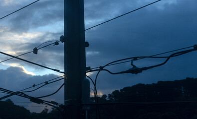 Electricity pole and wires at sunset. Wellington New Zealand.