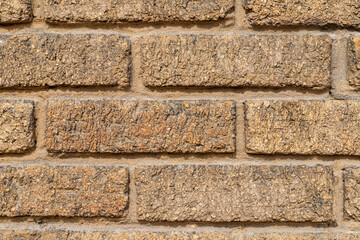 Brown brick old wall of a building, texture background, close-up