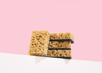 Soft porous dishwashing sponges lay on the table. Natural devices for cleaning.