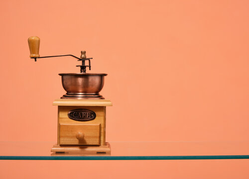 Manual coffee grinder on the surface. Copy space for text.