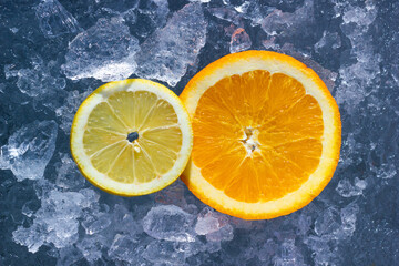 The sliced lemon and orange fruits on ice crystals. Fresh and natural healthy food with vitamins. - 723967698