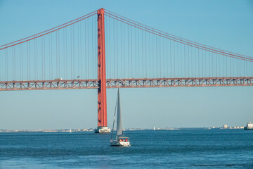 Sailing under the Tagus River Bridge, Lisbon, Portugal