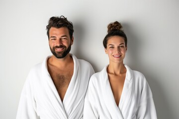 Man And Woman In White Bathrobes On White Background