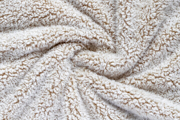 Beige soft plush fabric of cozy plush throw