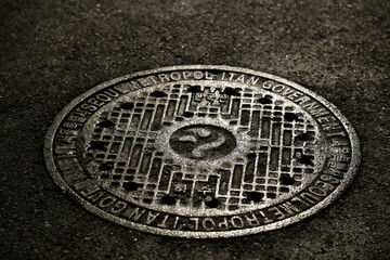 manhole cover in Seoul, Korea at night