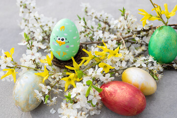 Colorful Easter eggs with spring blossoming cherry twigs. Tenderness, calmness, harmony. Blooming spring. Easter concept