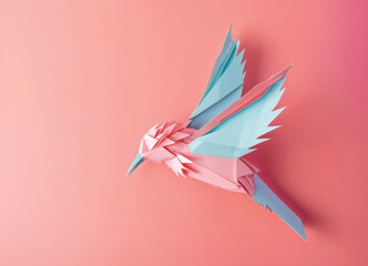 An origami hummingbird in shades of pink and teal suspended in motion, set against a complementary pink backdrop - 723994022
