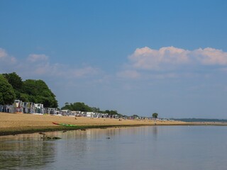 beach huts at Calshot Hampshire England on a bright sunny day