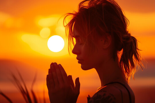 Woman praying to god outdoor at sunset, doves, pigeons and birds flying around