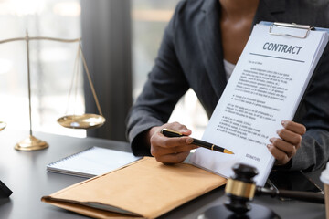 A lawyer is preparing documents for his client to sign.
