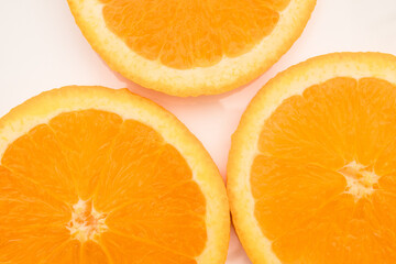 Fresh sliced oranges on a light background