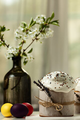 Traditional Orthodox Easter cakes and colored eggs, on a white table in the middle plan on a light background. happy Easter