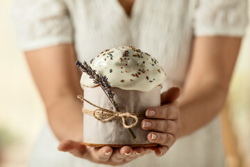 traditional Orthodox Easter cake, in women's hands, close-up on a light background. happy Easter