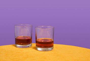 Two whiskey glasses on the table. Pleasant holiday, party, alcohol. Copy space for text.