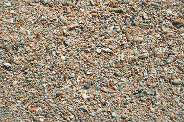 Coral reef on sandy beach. Dead coral reefs carried by the waves on the shoreline. Piled up like pebbles. Background of coral reefs and shells on the beach.