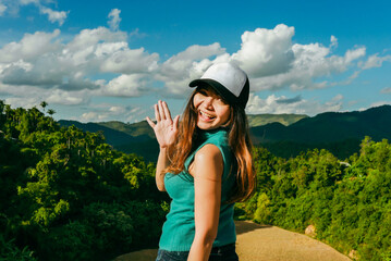 Young asian woman happy smiling at mountain peak. happy Asian girl on blurred mountain sunrise background. Thailand, Asia