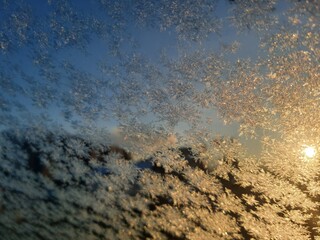 Ice crystals formations on glass car window.
