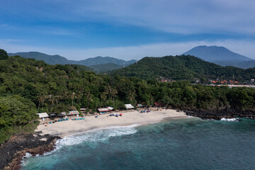 Fototapeta na wymiar Landscape of the white sand beach of Bias Tugel situated near Padangbai harbour in Bali Indonesia with the volcano Agung nearby.
