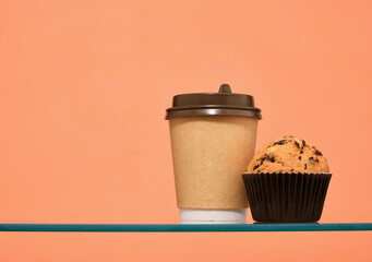 Fresh hot coffee and a muffin with chocolate chunks. Copy space for text.